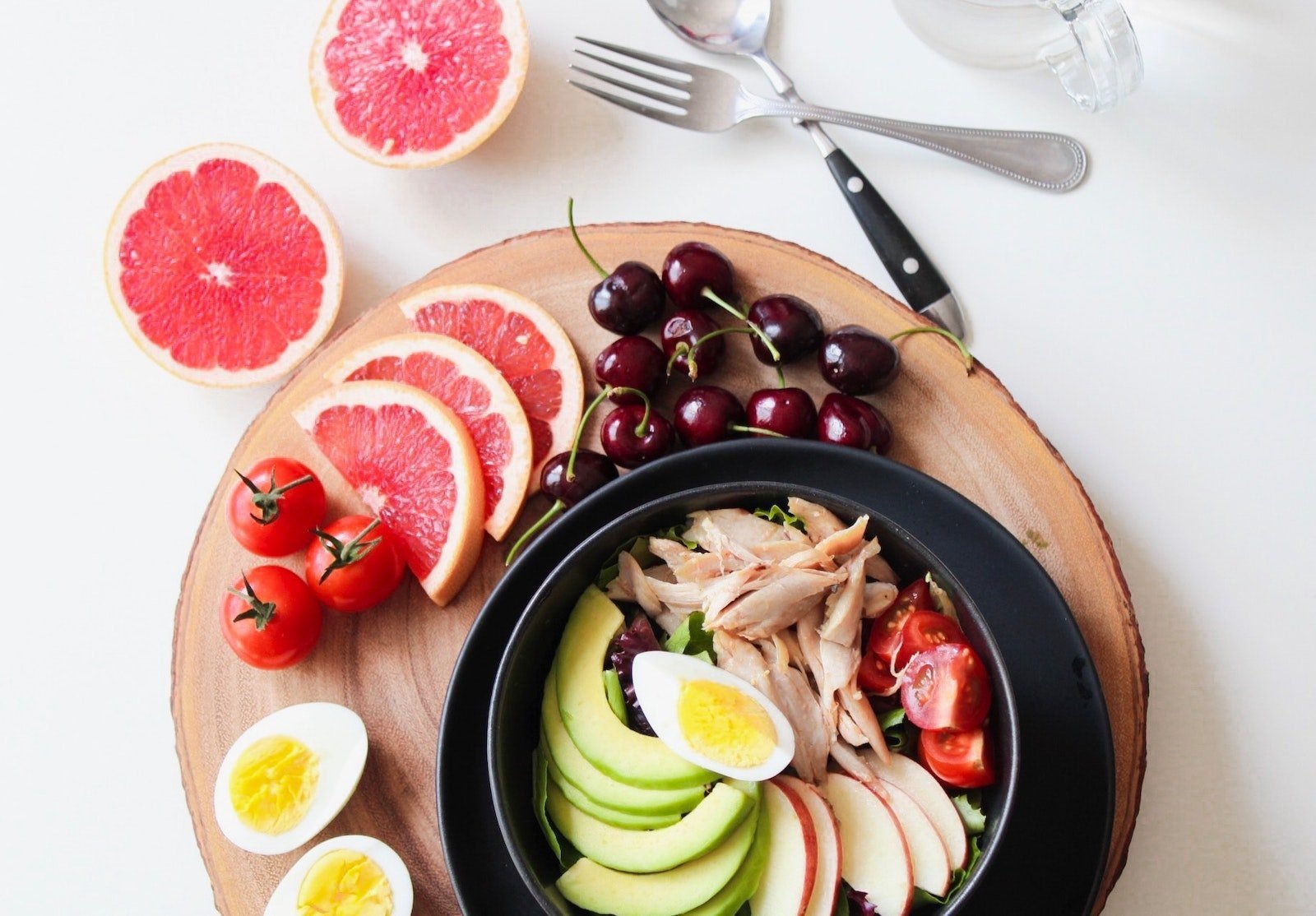Bowl of Vegetable Salad and Sliced Fruits